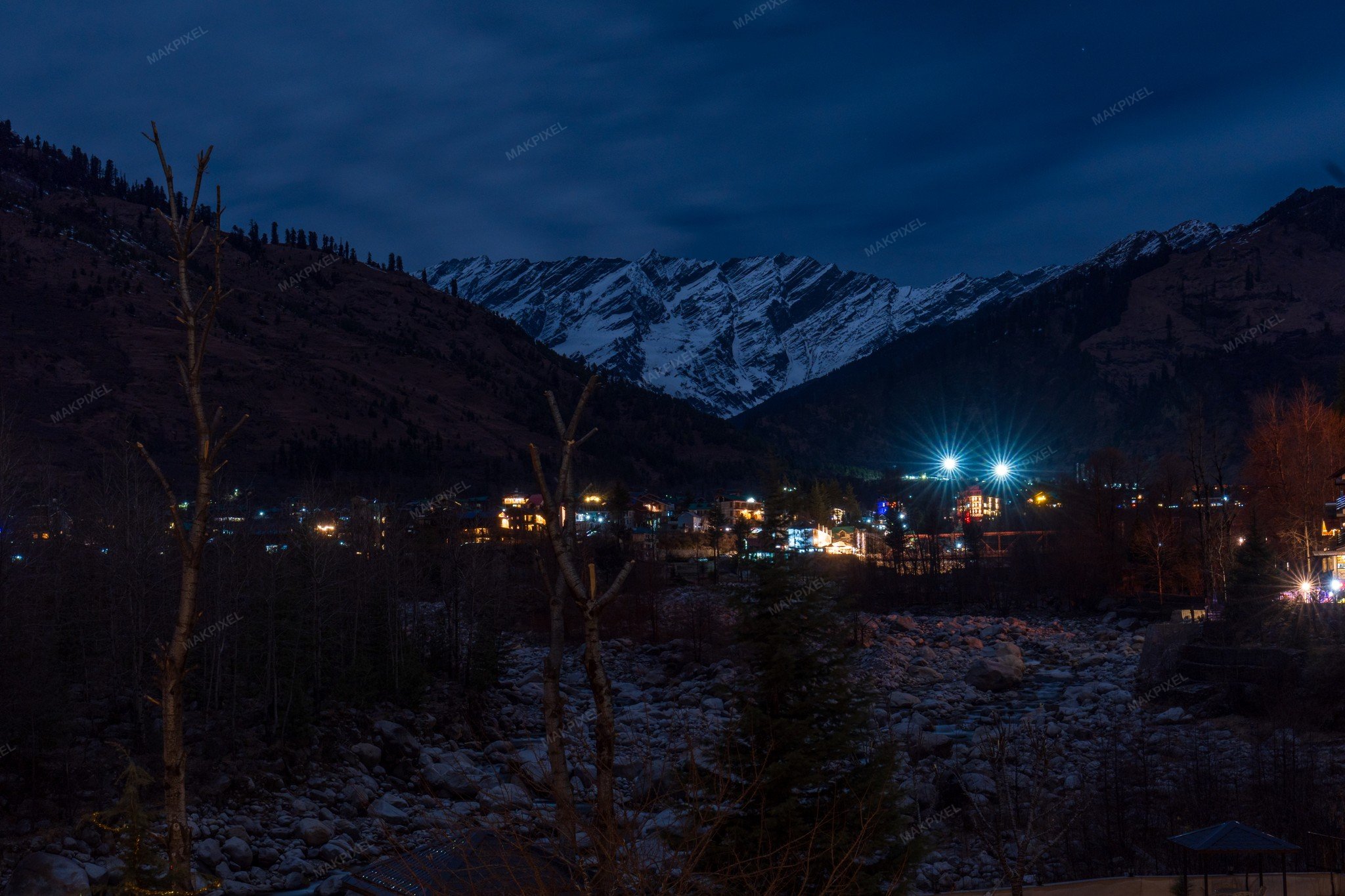 A scenic view of a mountainous area at night with snow-ca... - Full size view
