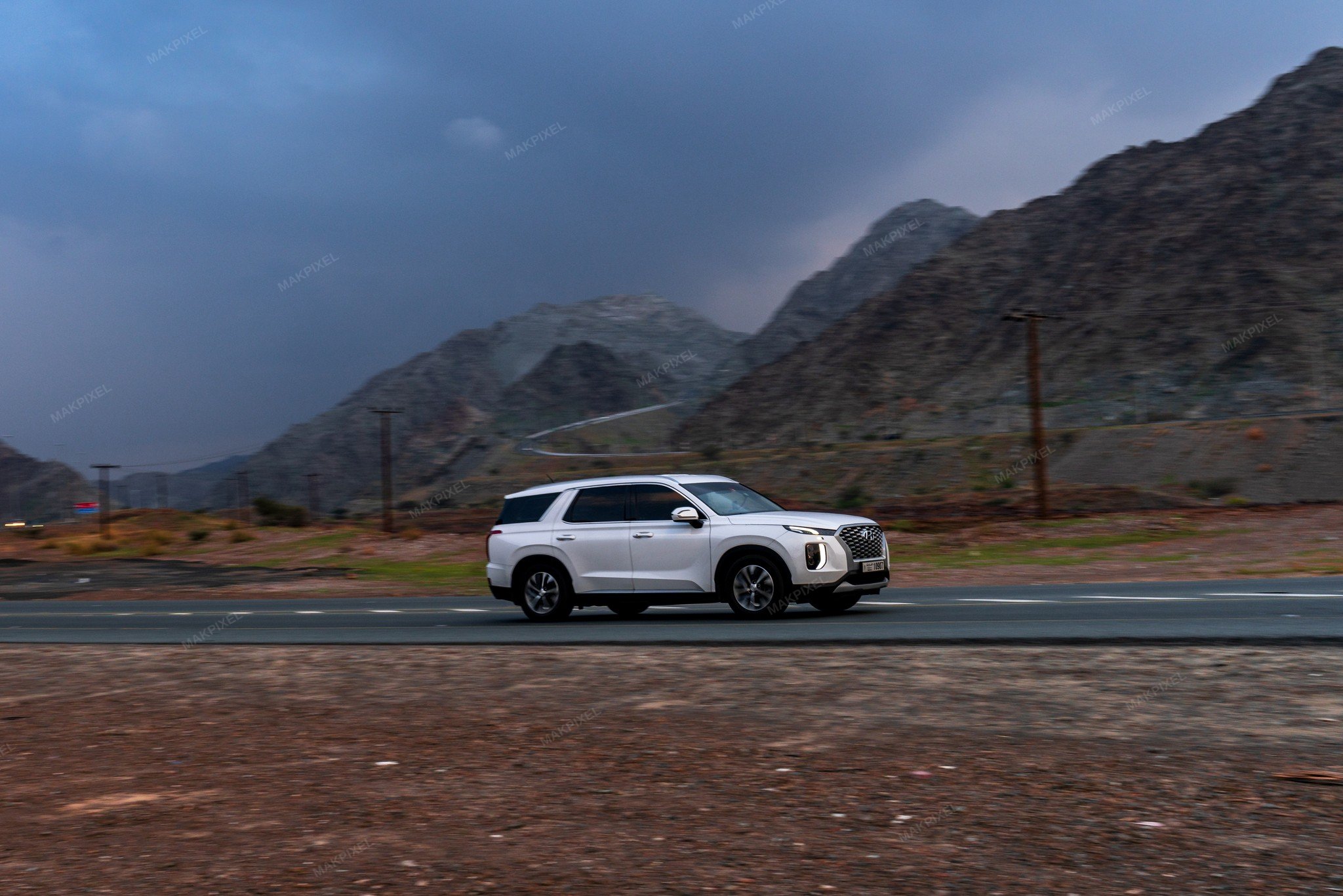 Desert landscape with a vehicle on a road - Full size view
