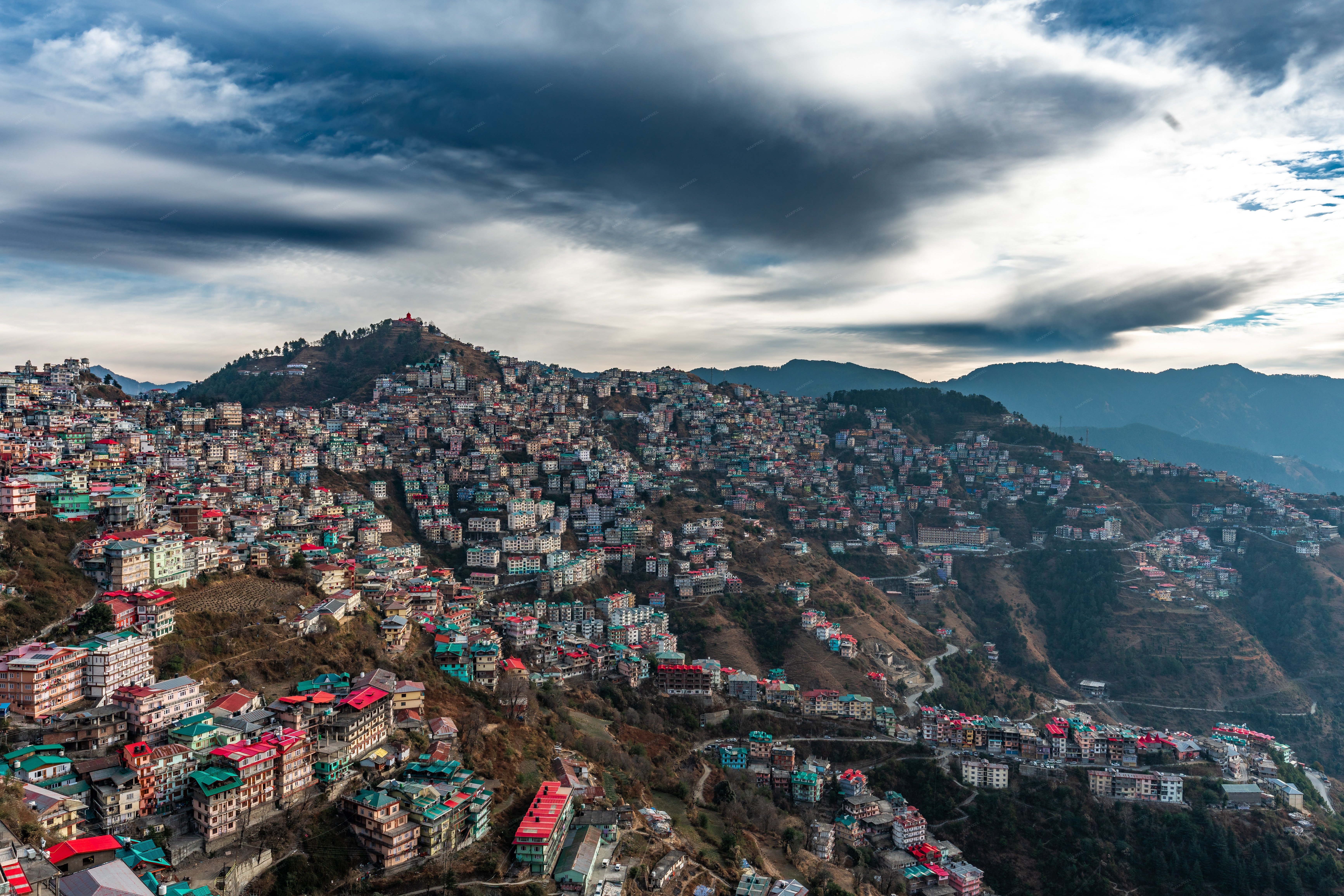 Aerial view of a mountainous region with terraced houses and a clou... - Full size view