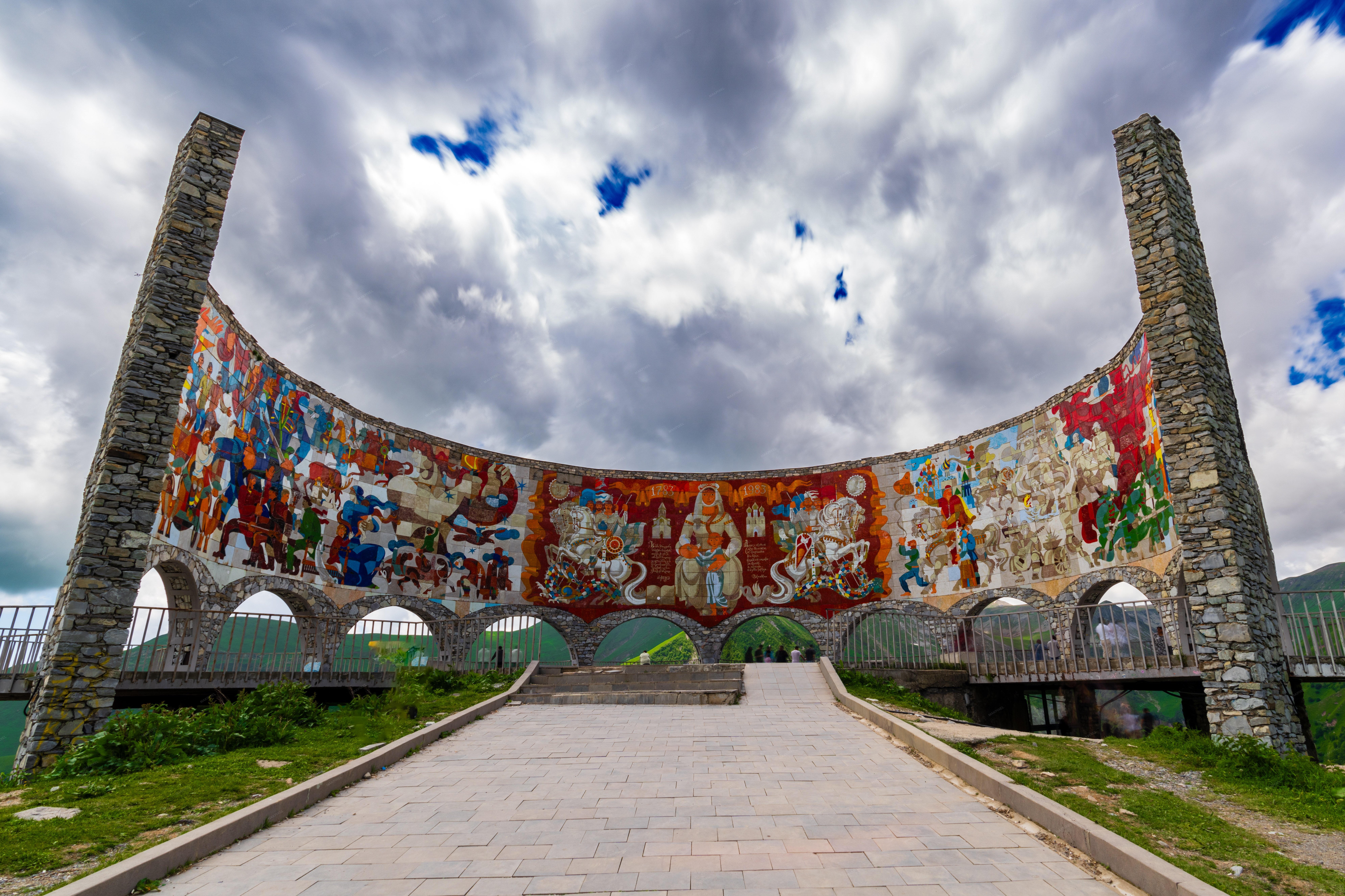 large, colorful mosaic archway with a stone base  on Tbilisi, Georgia - Full size view