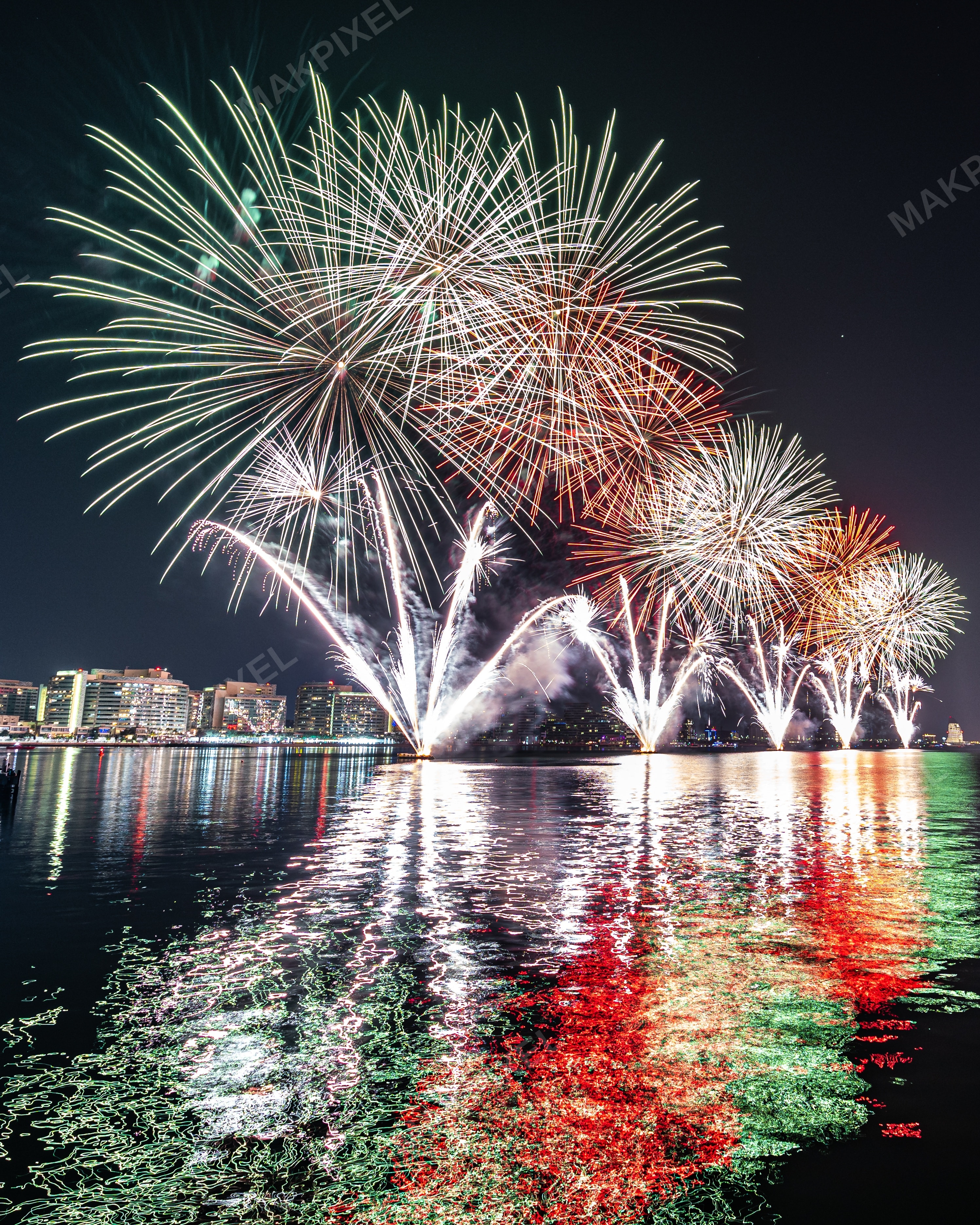 Fireworks Over Abu Dhabi City Skyline at Night – Colorful Reflections - Full size view
