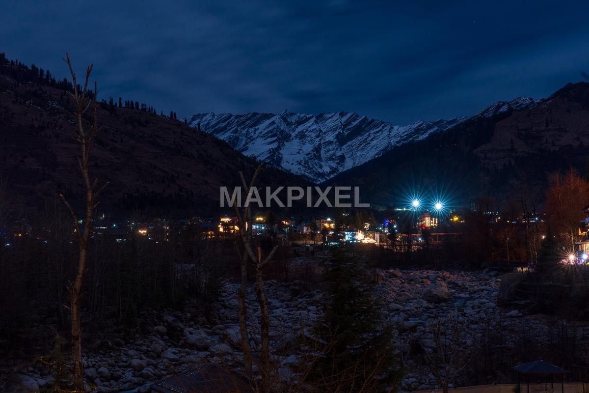 A scenic view of a mountainous area at night with snow-ca... - 2048×1365 stock photo