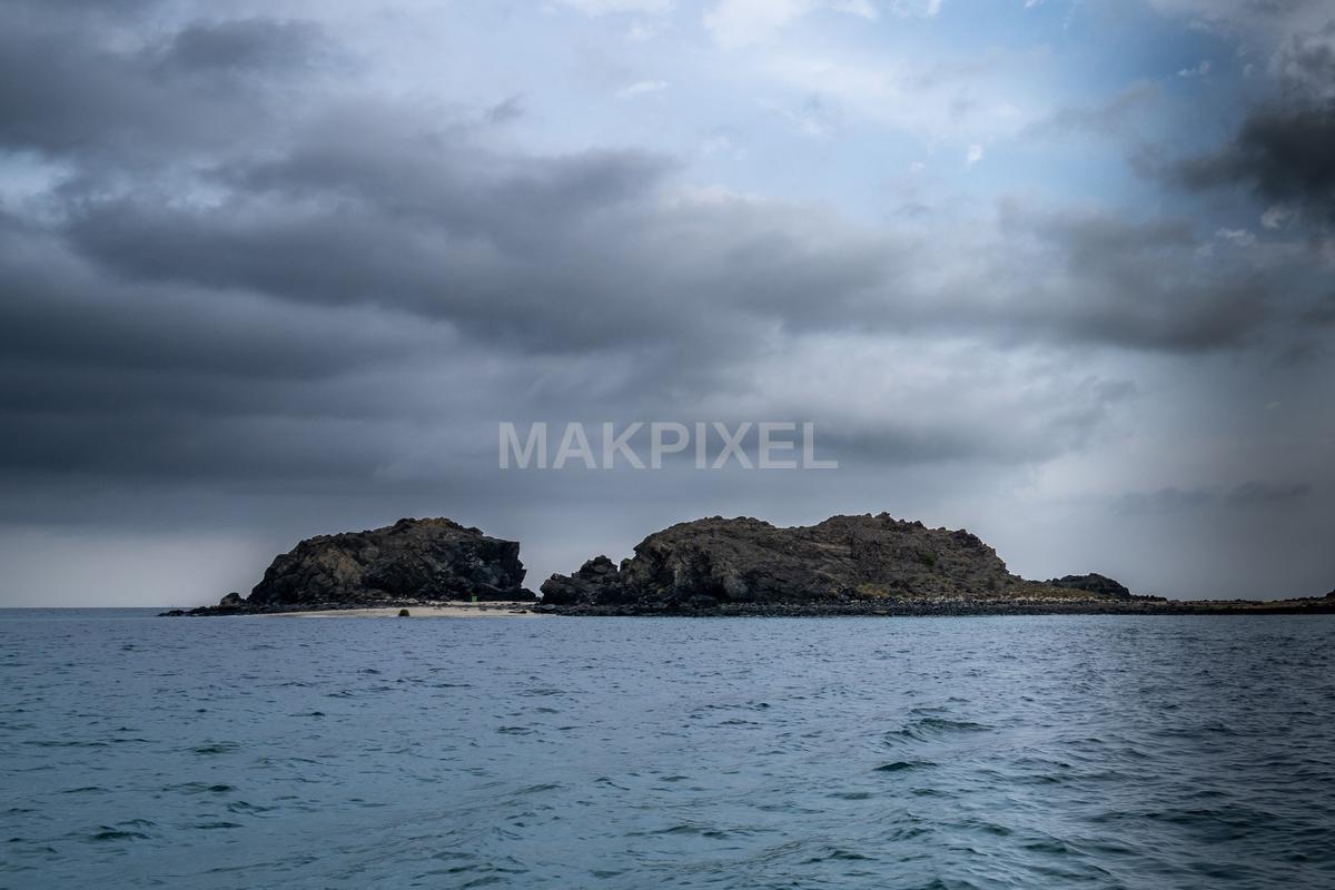 Rocky island in the ocean - 2048×1365 stock photo