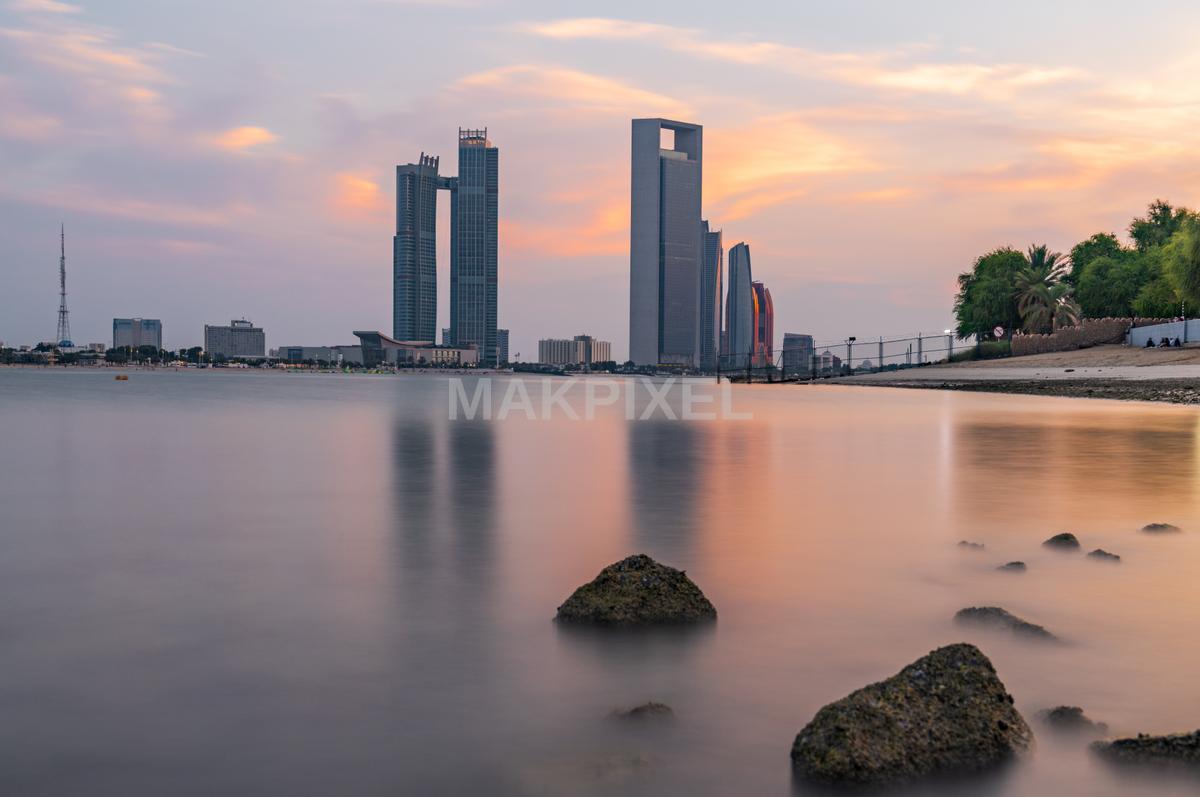 beautiful sunset over a body of water with a city skyline in - 7602×5050 stock photo