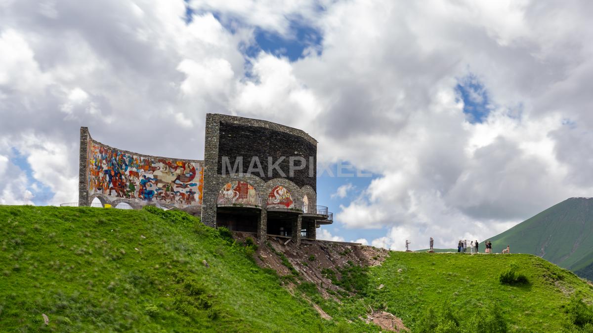large, colorful mural on a stone wall in the foreground, - 7370×4146 stock photo