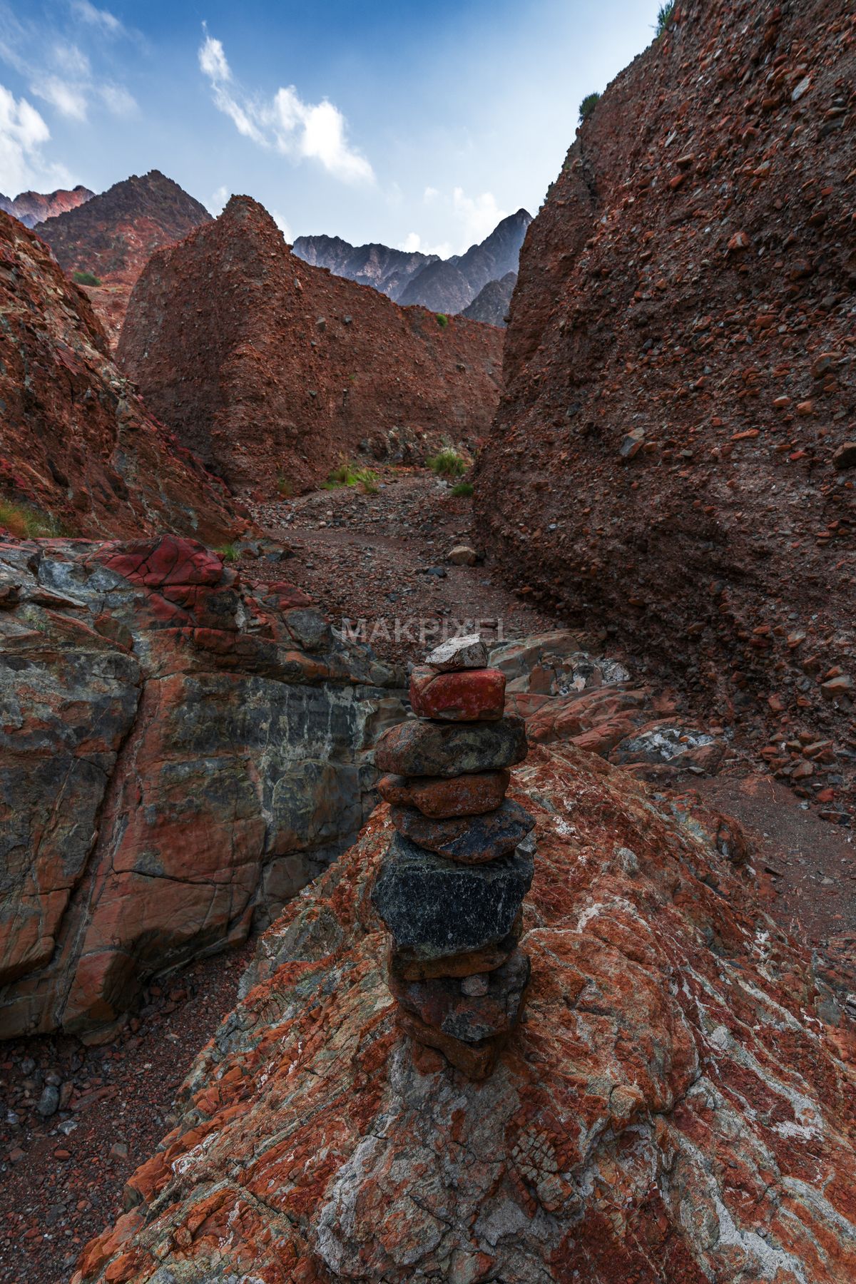 Stacked Stones in Red Rocky Canyon, Masafi Mountains UAE - 5593×8390 stock photo