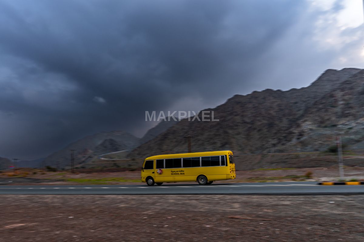 Yellow School Bus on Mountain Road, Masafi UAE – Dramatic Landscape - 7047×4698 stock photo