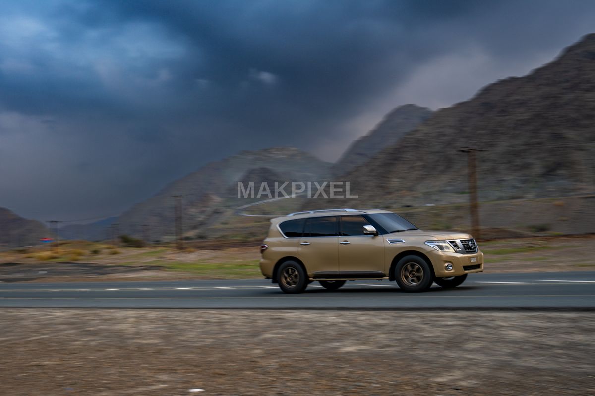 Nissan Patrol Gold SUV on Mountain Road, Masafi UAE – Adventure Travel - 7408×4939 stock photo