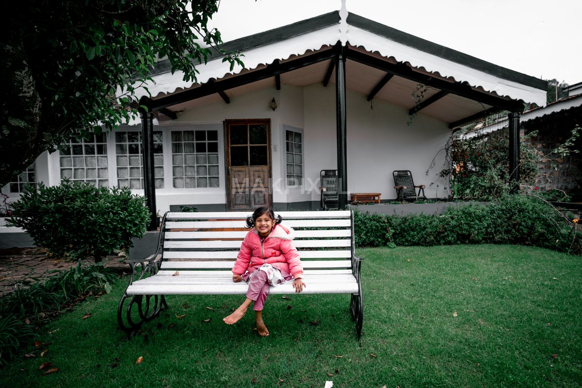 Cozy Cottage with Child on Garden Bench – Autumn Mood, Minimalist - 6289×4193 stock photo