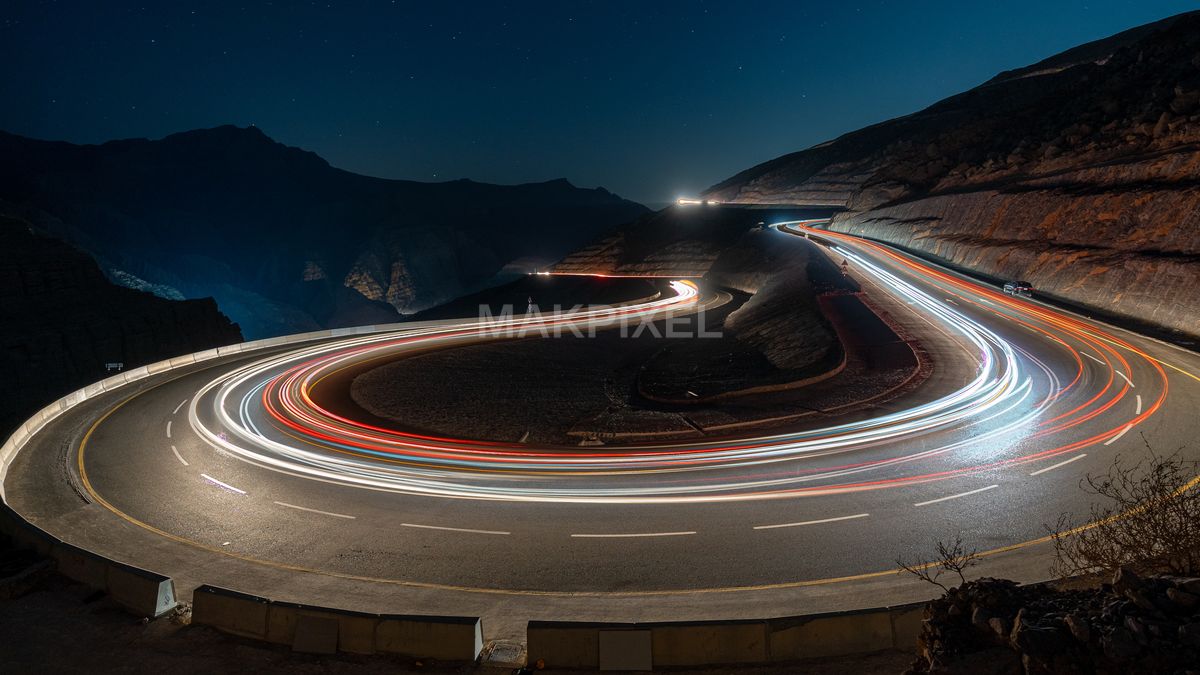 Mountain Road Light Trails at Night – Long Exposure Curves in UAE - 5852×3292 stock photo