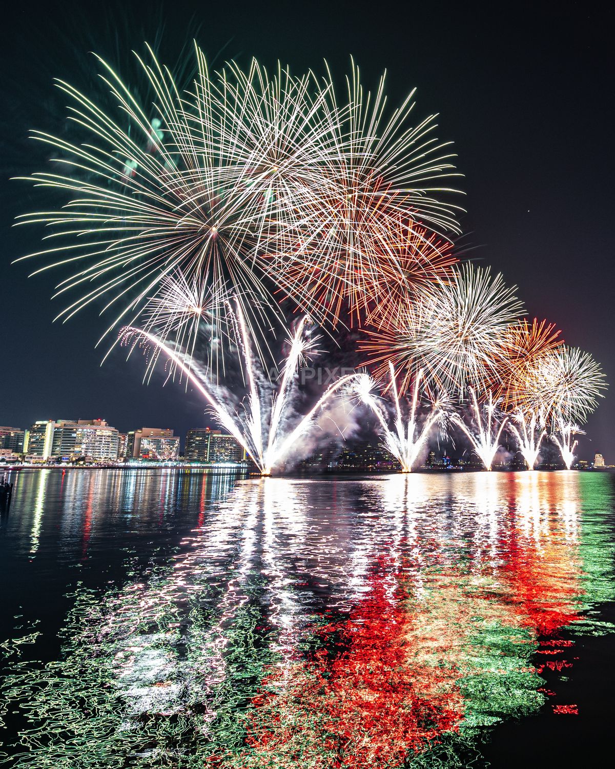 Fireworks Over Abu Dhabi City Skyline at Night – Colorful Reflections - 2994×3742 stock photo