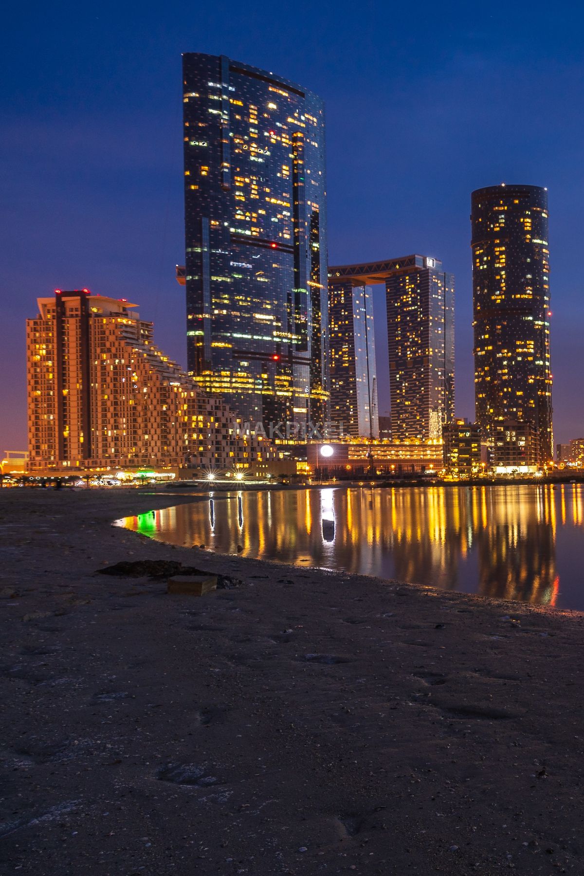 Abu Dhabi Modern Skyline at Blue Hour – Illuminated Towers and Reflect - 2172×3258 stock photo