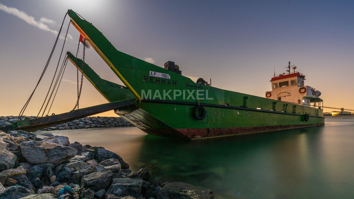 Green Barge Docked at Night – Moonlit Waterfront Harbor, Ras Al Khaima - 5721×3218 stock photo