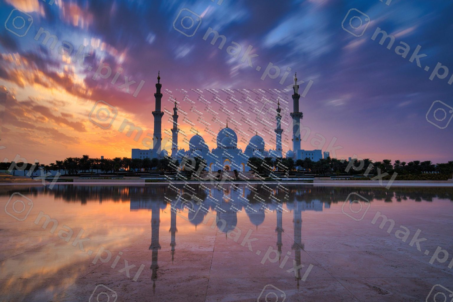 The Sheikh Zayed Grand Mosque at sunset, with colorful clouds and orange-purple sky reflecting in the still water in front of the grand, domed structure and tall minarets.